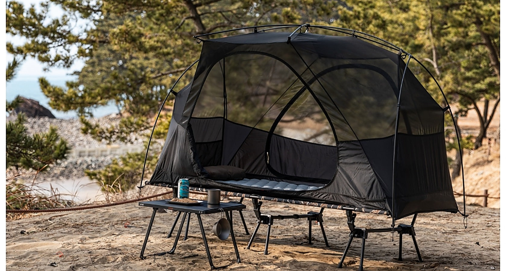 Base Cot Tent pitched in a pine forest campsite