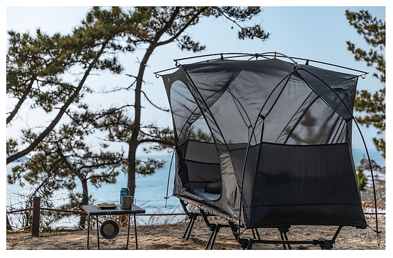 Base Cot Tent pitched at a coastal pine forest campsite