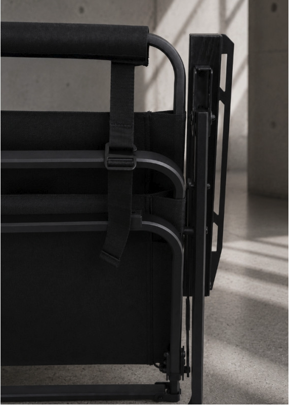 FLOW folding chair folded flat, rear view showing the securing buckle strap