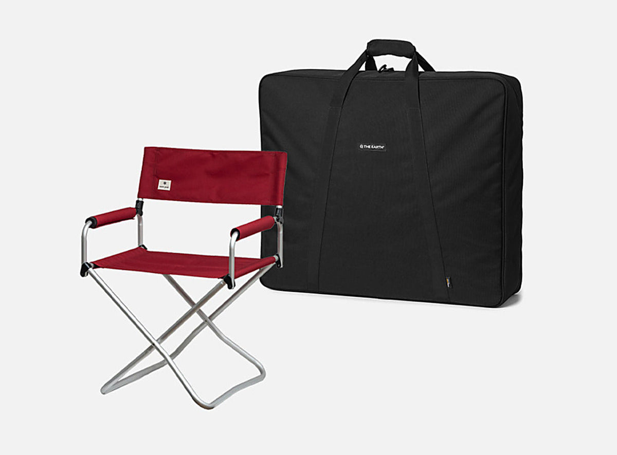 Black CORDURA FD Chair Case standing beside an unfolded red camping chair for scale