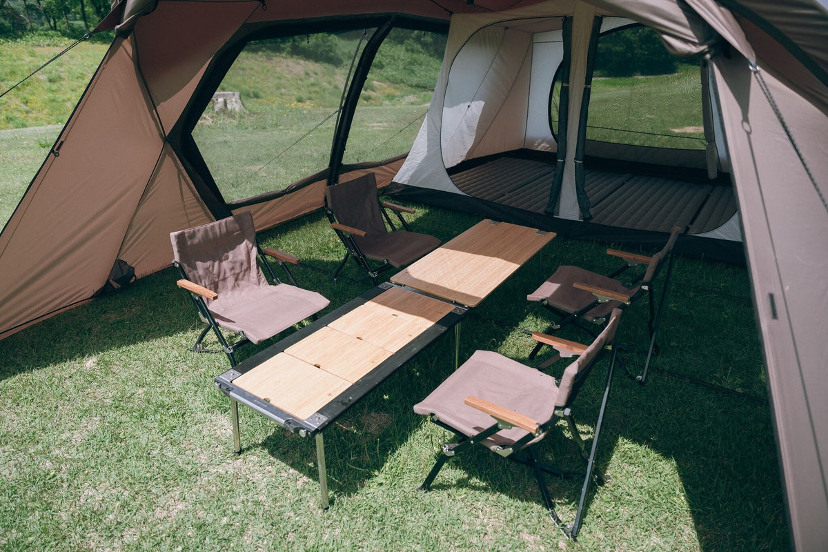 Land Lock X, Brown, living area set up with a low table and camp chairs