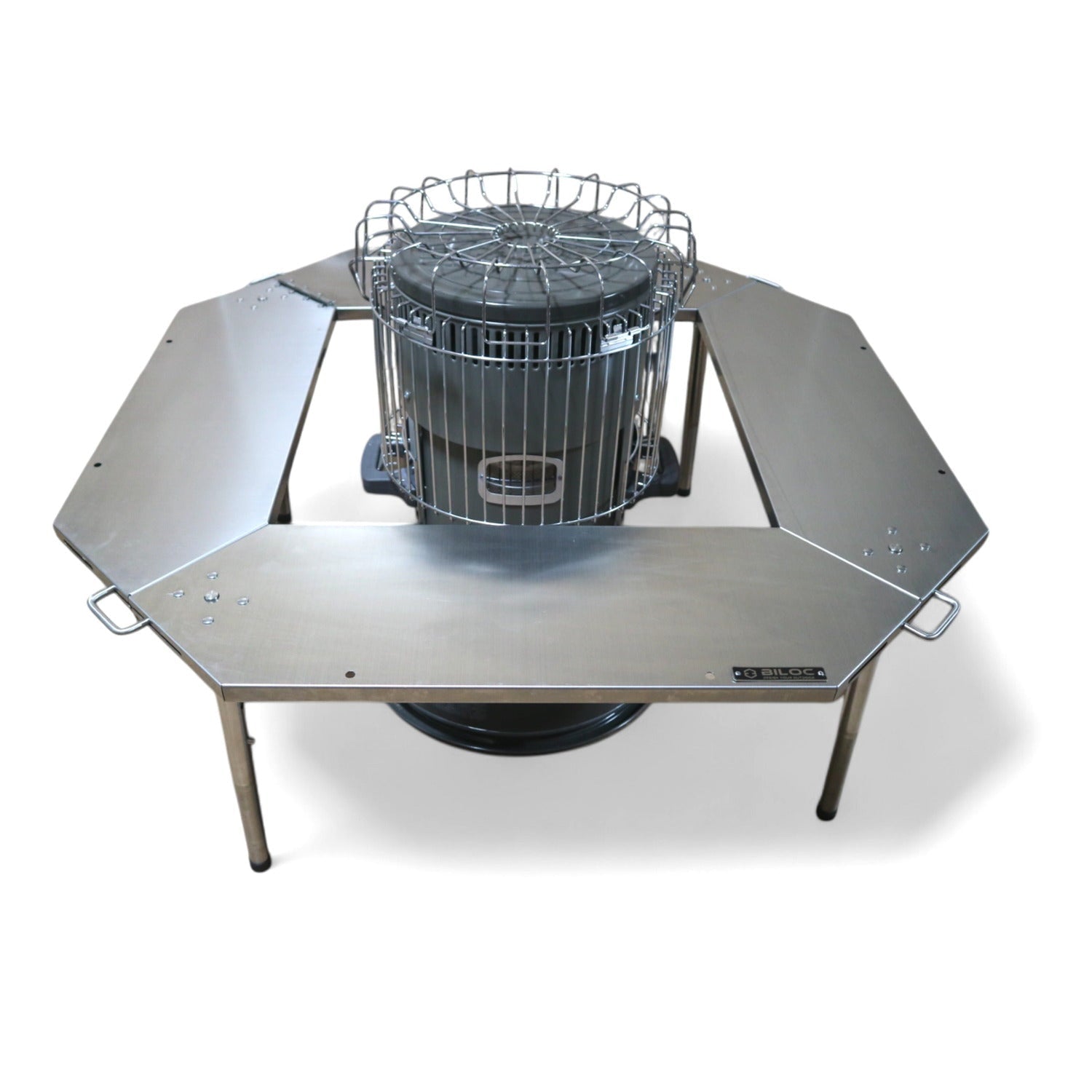 Octa table ringing a cylindrical camp heater that stands on the ground through the centre opening.