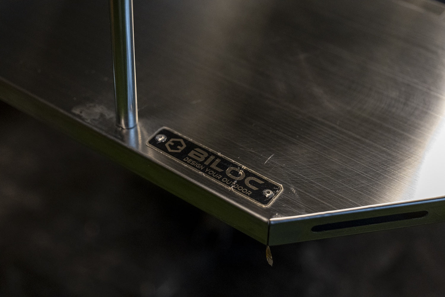 BILOC nameplate reading Design Your Outdoor on the edge of an Octa table plate, beside the IGT rail slot.