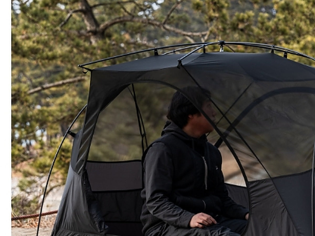 Person sitting upright inside the tent with full headroom