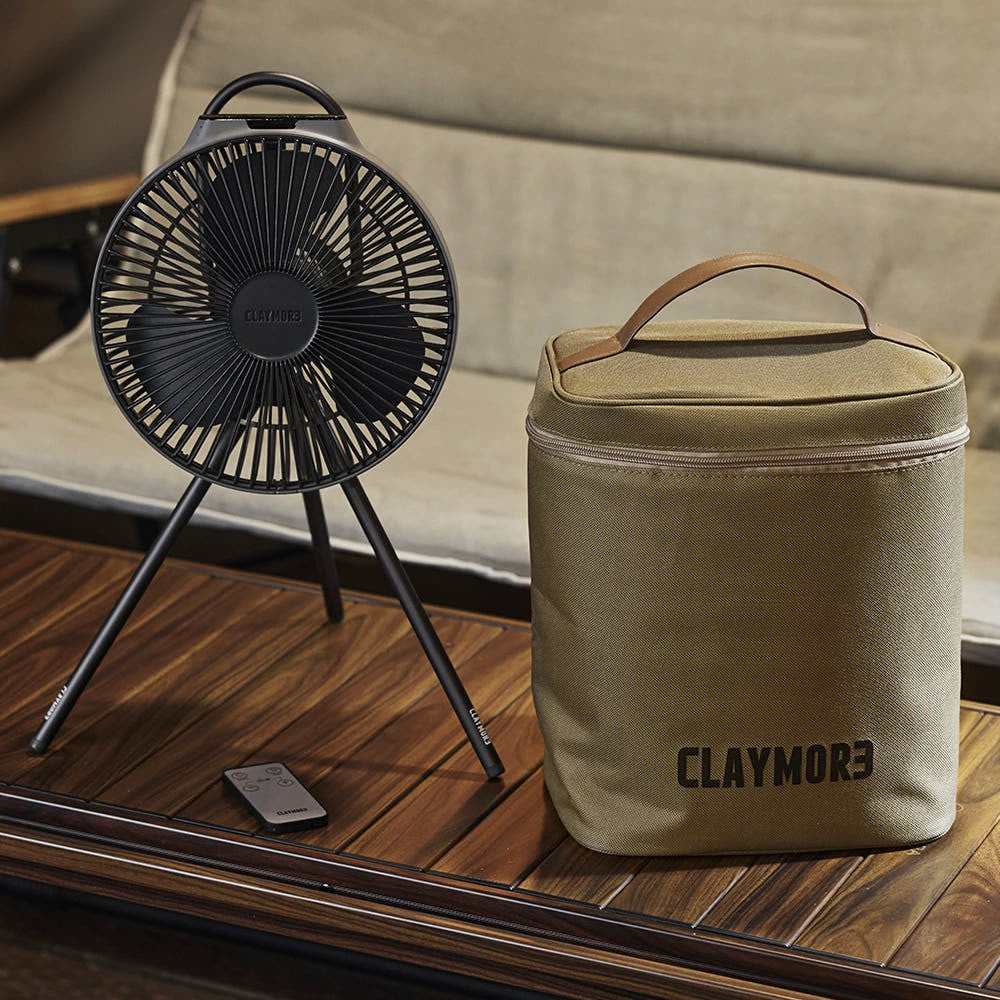 V1040 fan on its tripod beside the tan V1040 size pouch on a camp table