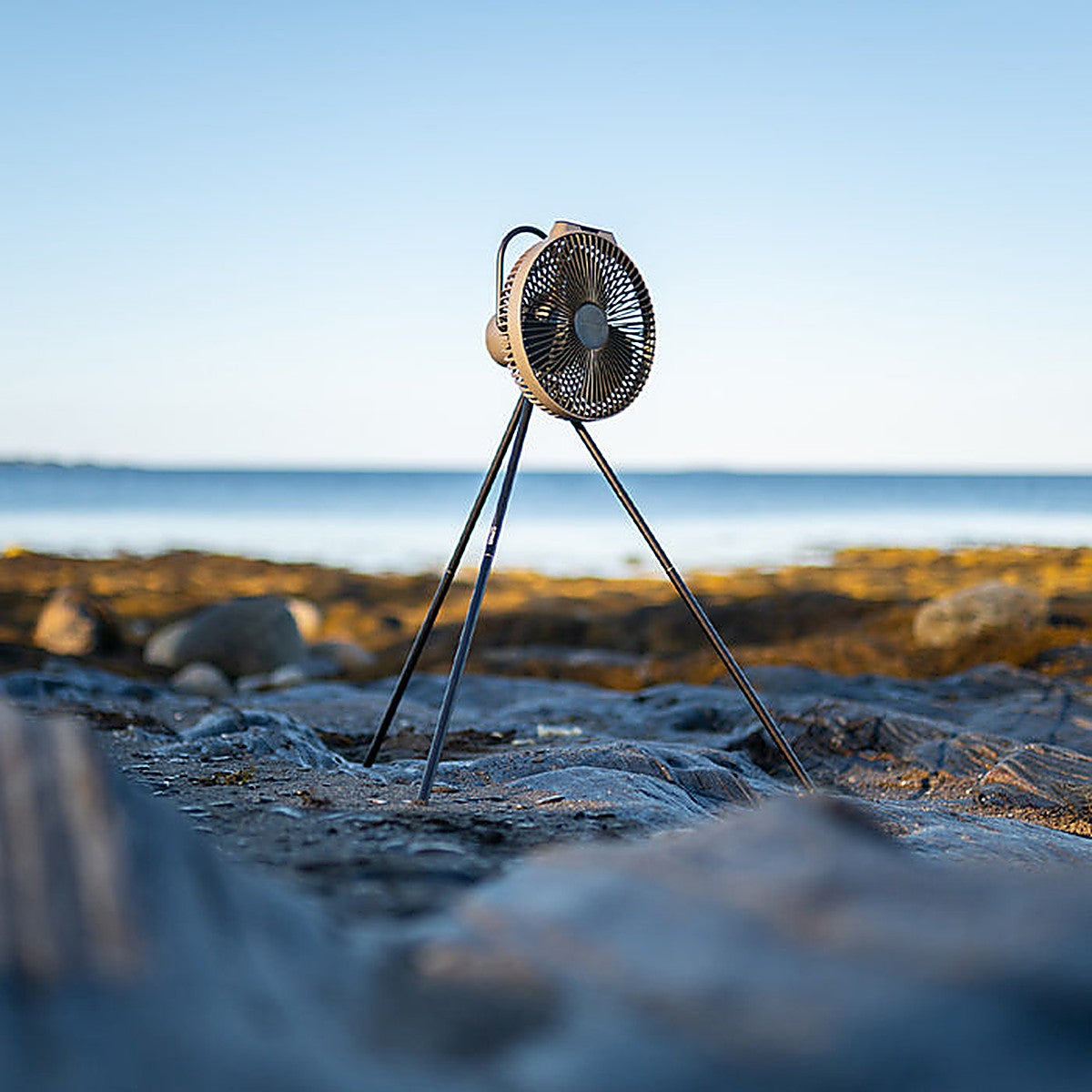 CLAYMORE V1040 circulator fan running on rocks by the sea, moving open-air