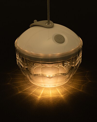 Crystal Shade, fitted to a lit lantern at night, casting a faceted light pattern