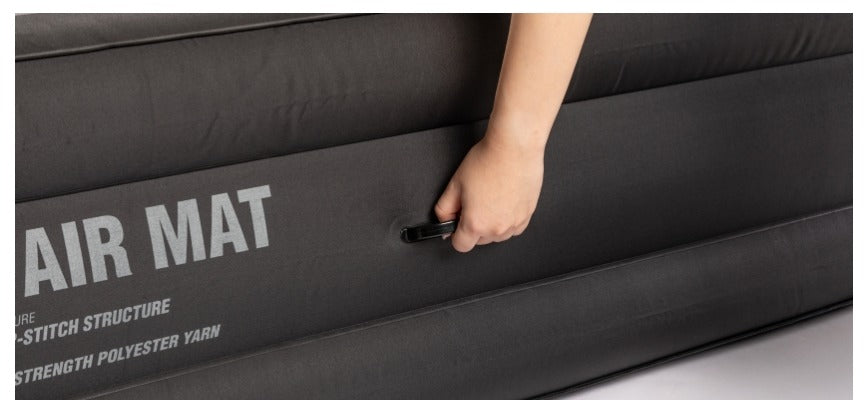 Hand gripping a side carry handle