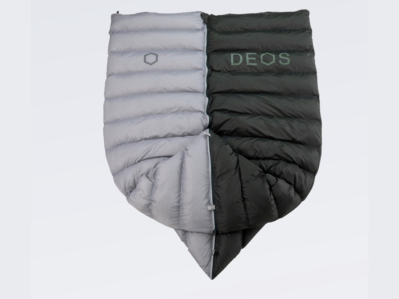 Two DEOS camp comforters zipped together into one double duvet
