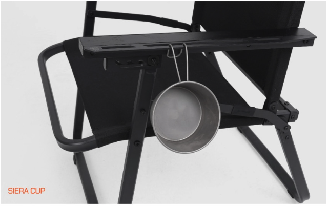 Sierra cup hanging from the side slot of the FLOW folding chair armrest