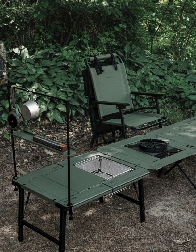 Khaki FLOW folding chair behind a modular camp kitchen table setup