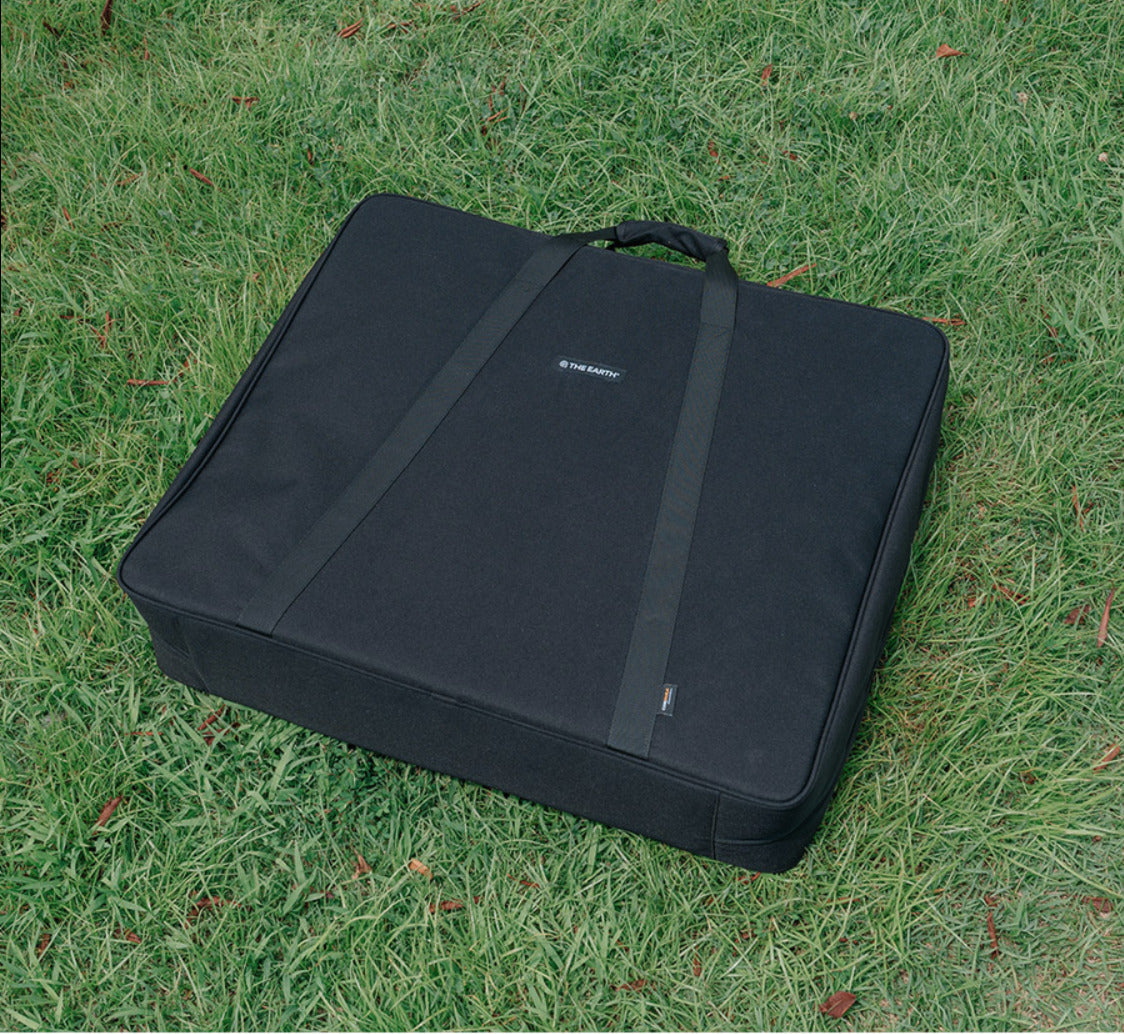 Closed Wolf Grey CORDURA FD Chair Case resting on grass, three-quarter view