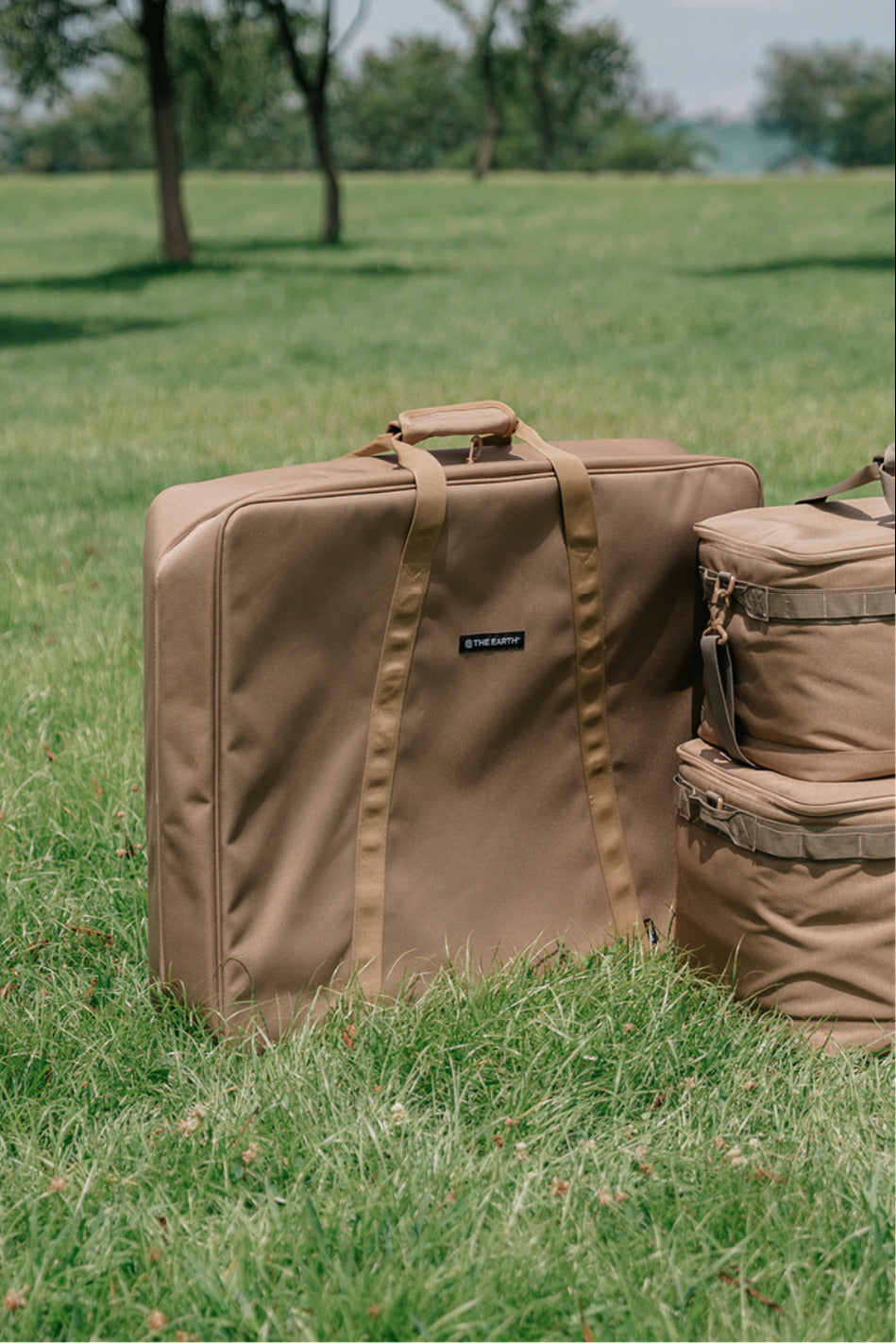 Coyote Tan CORDURA FD Chair Case standing on grass in a field