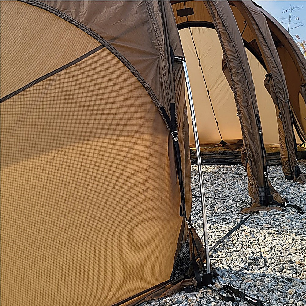 Spare metal pole supporting a Gopamir air-beam shelter outdoors on a campsite