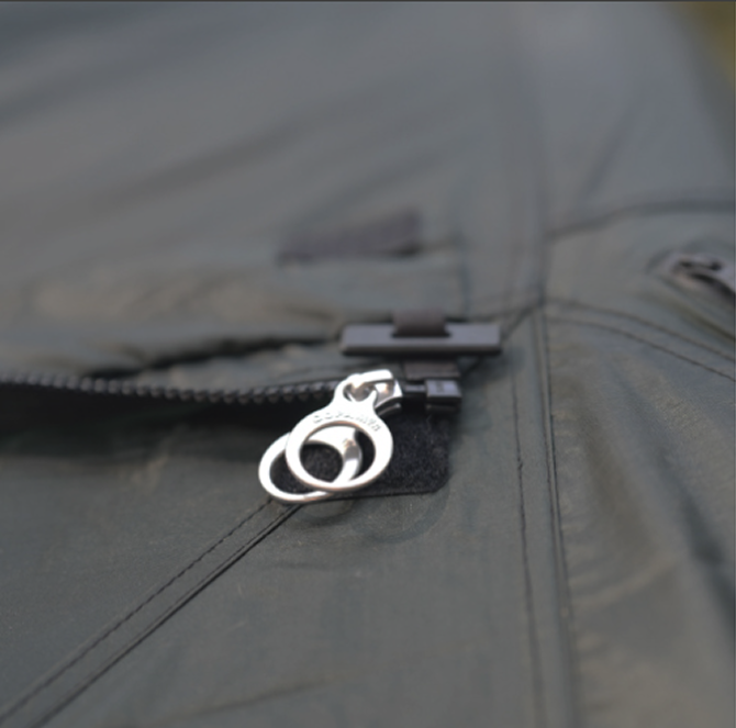 Close-up of the side tarp zipper with its O-ring pull where it connects along the shelter rain fly slider