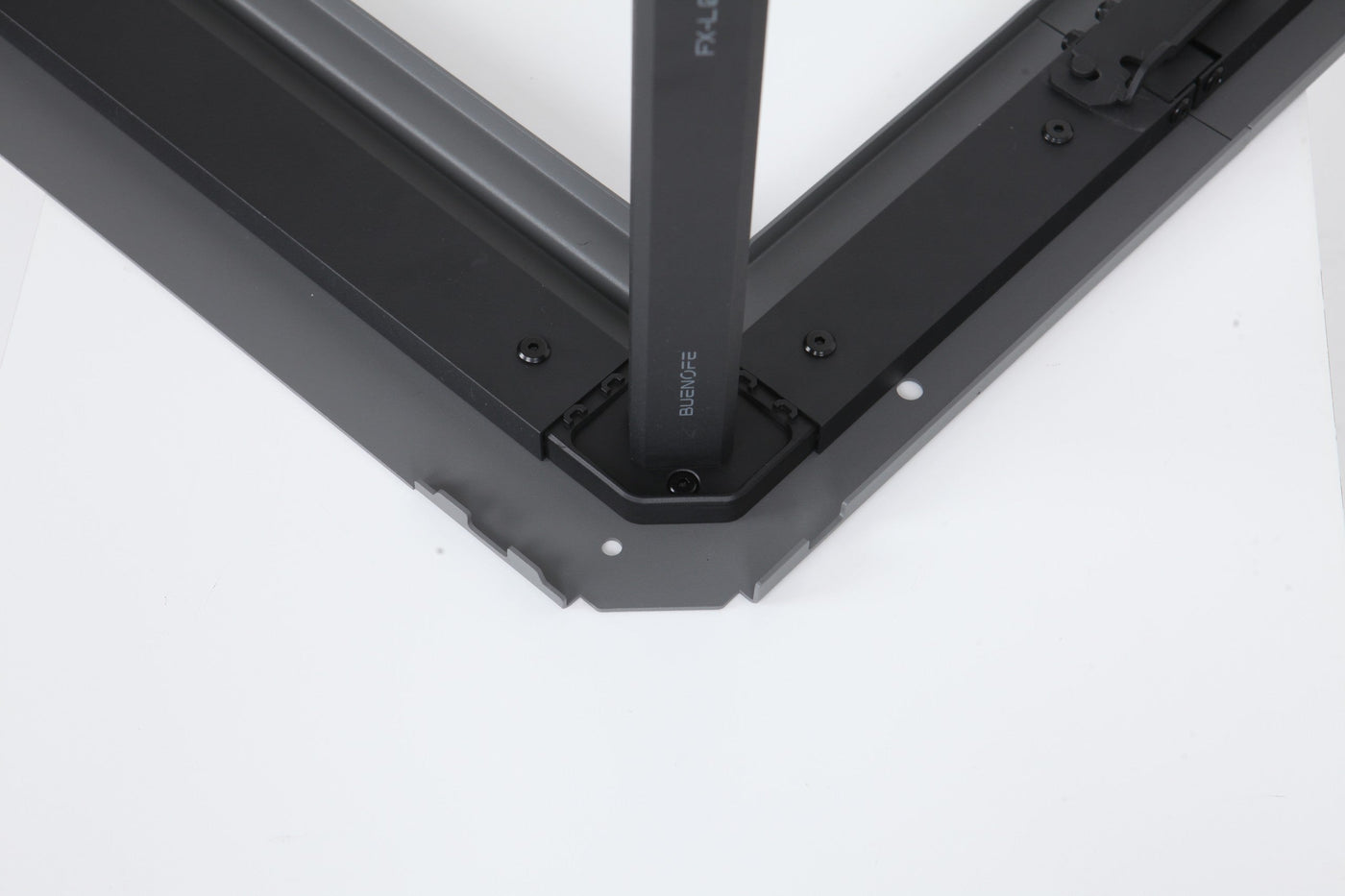 BUENOFE IGT Quick Slot Table Leg shown seated and locked upright into the corner of a black IGT frame on a white background, the engraved leg fully engaged in the frame groove after the twist-lock.
