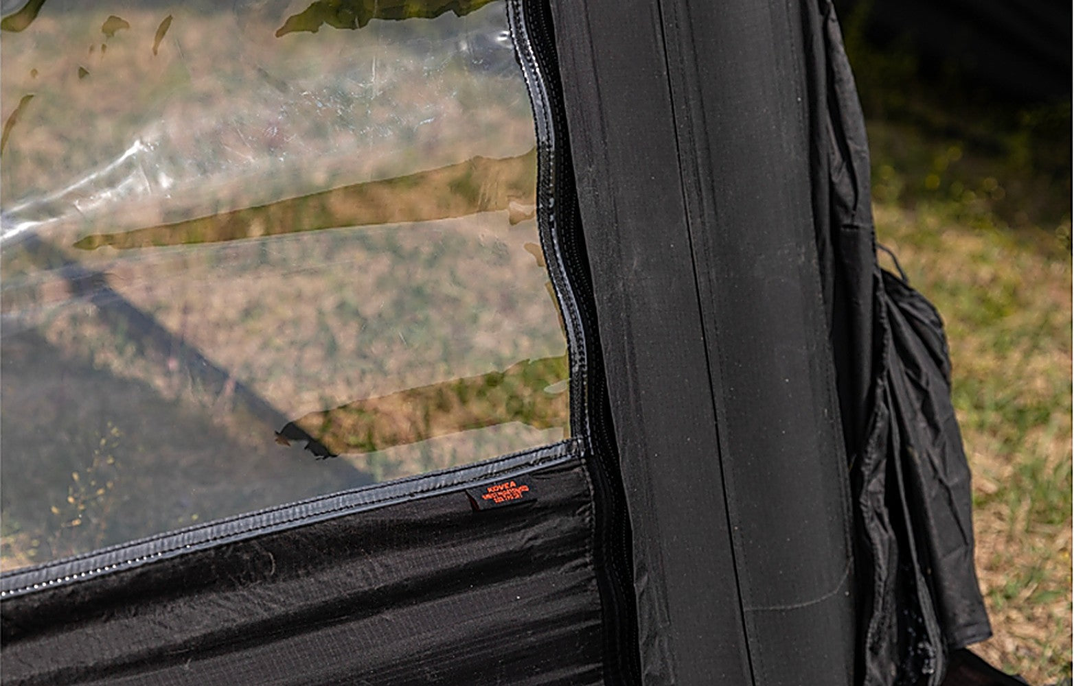 Close-up of the TPU panel edge sealed against the shelter with zipper and Velcro finish to block drafts