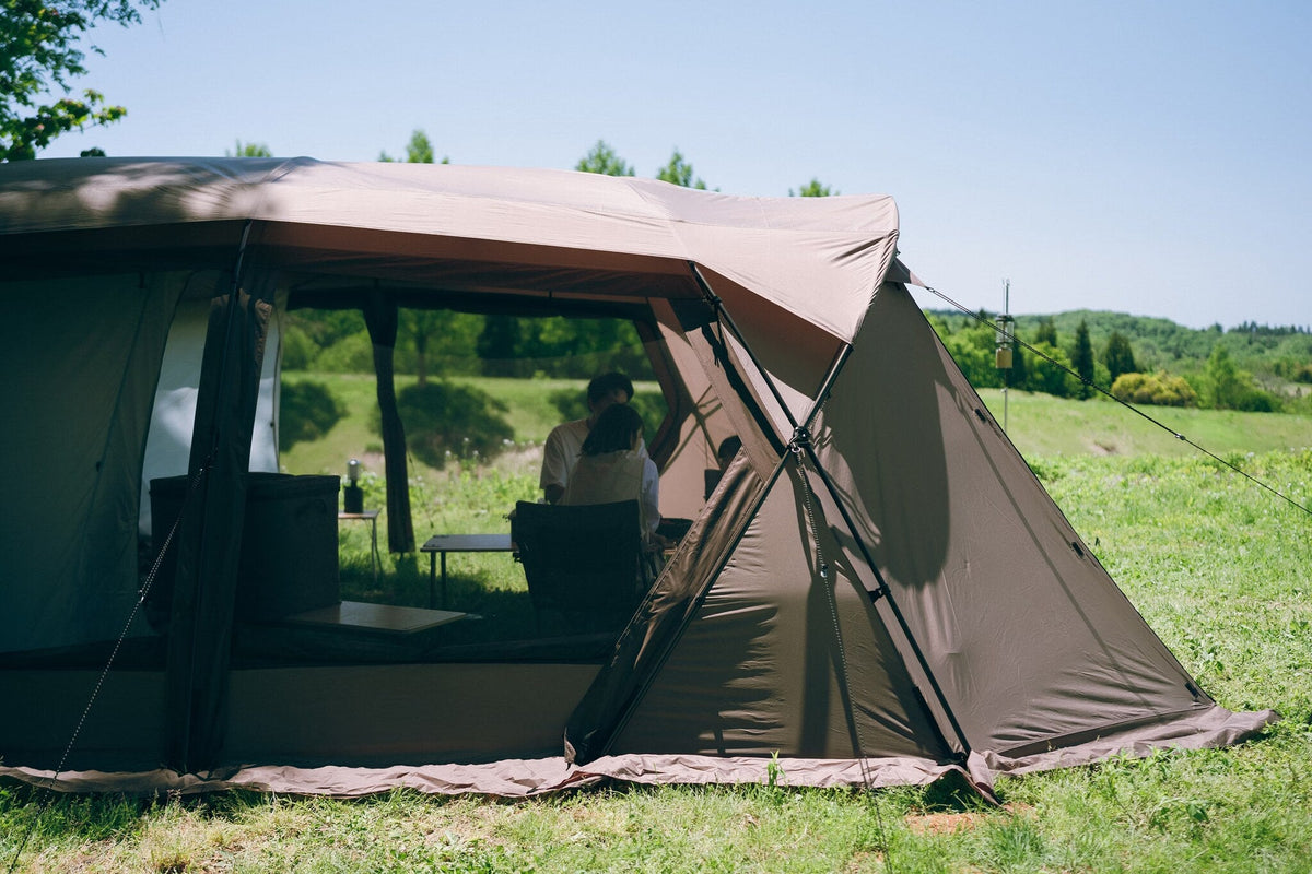 Land Lock X, Brown, front canopy raised as an awning at a woodland campsite