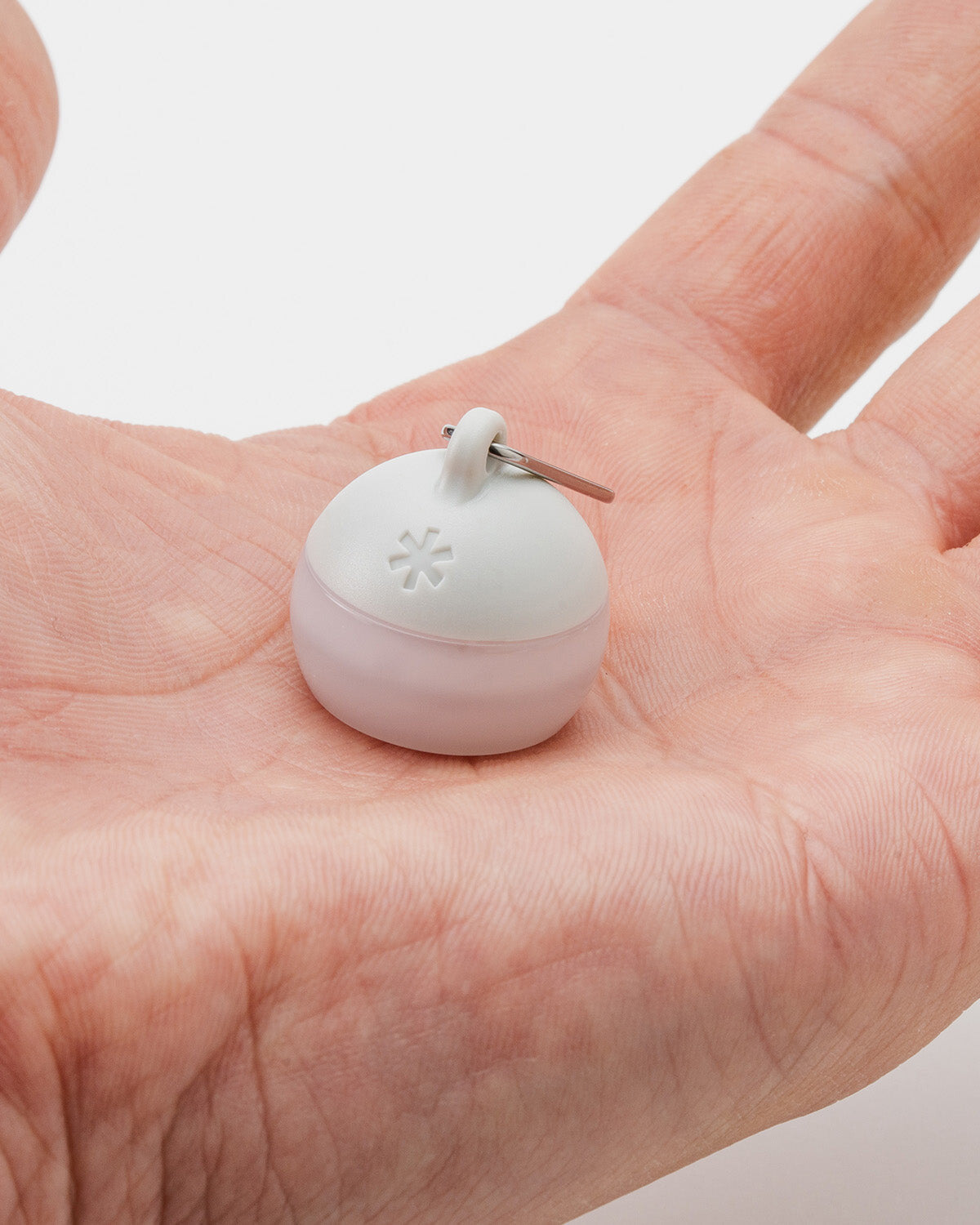 Micro Hozuki, Ivory, held in an open palm to show its size