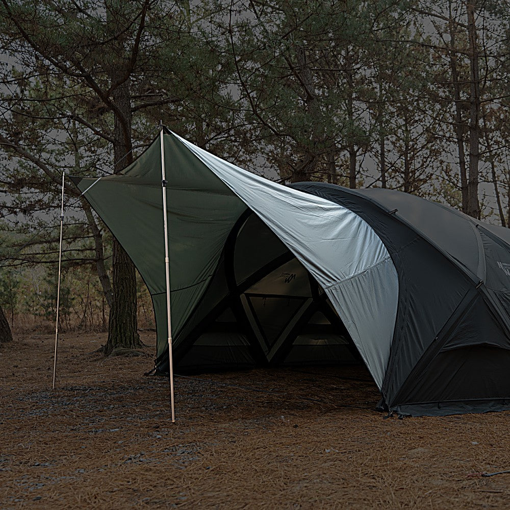 Porch wing extended like a tarp off the shelter front, propped with an upright pole over open ground