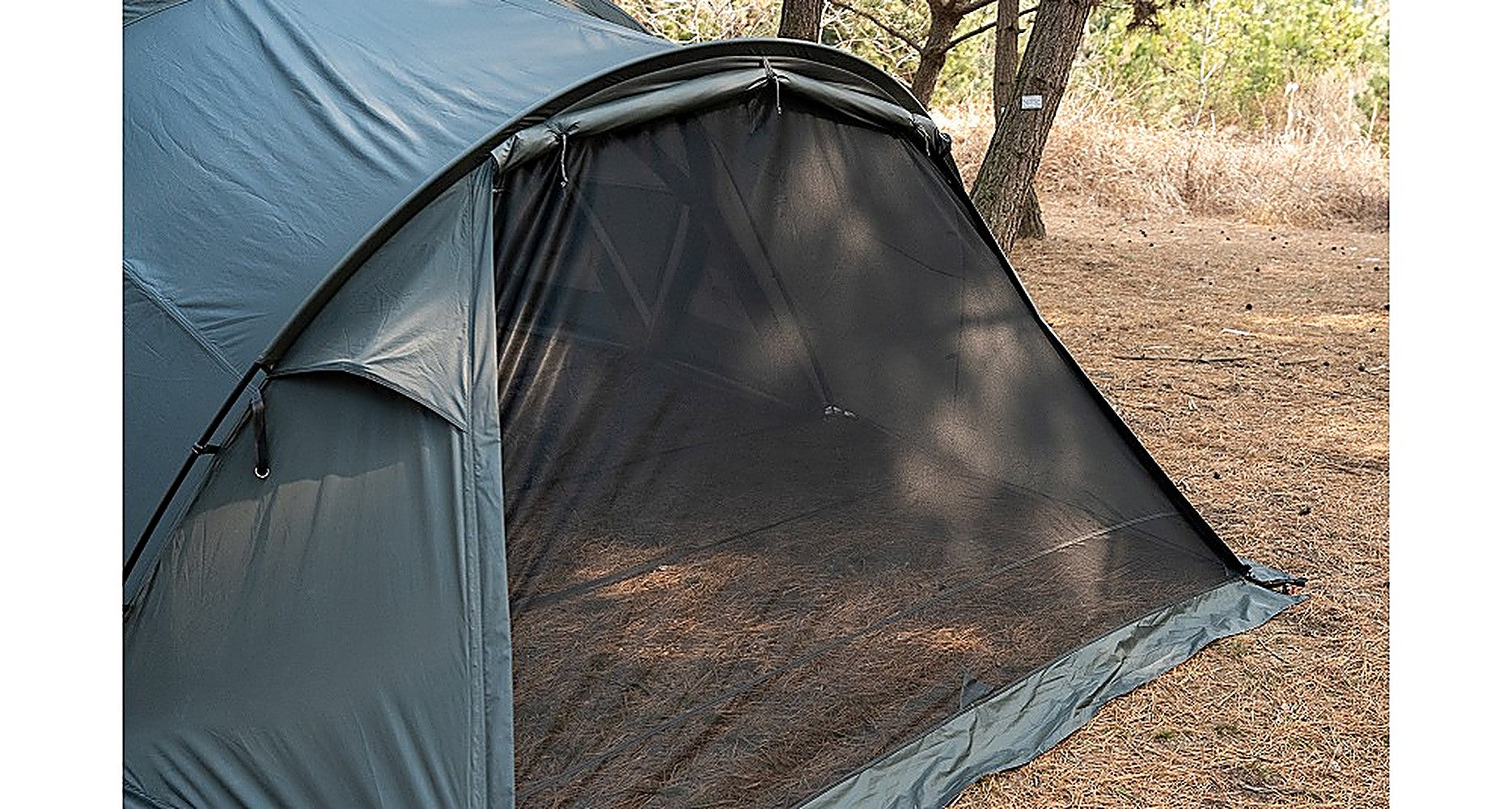 Shelter GM Vestibule front entrance with full mesh panel closed at a wooded campsite