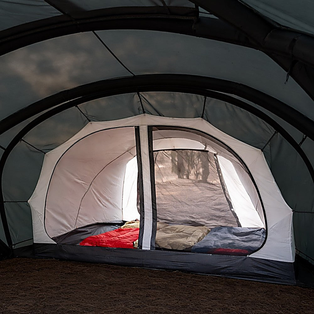White Vestibule Inner Tent pitched inside Shelter GM's dark green air-beam frame, sleeping bags seen through mesh door