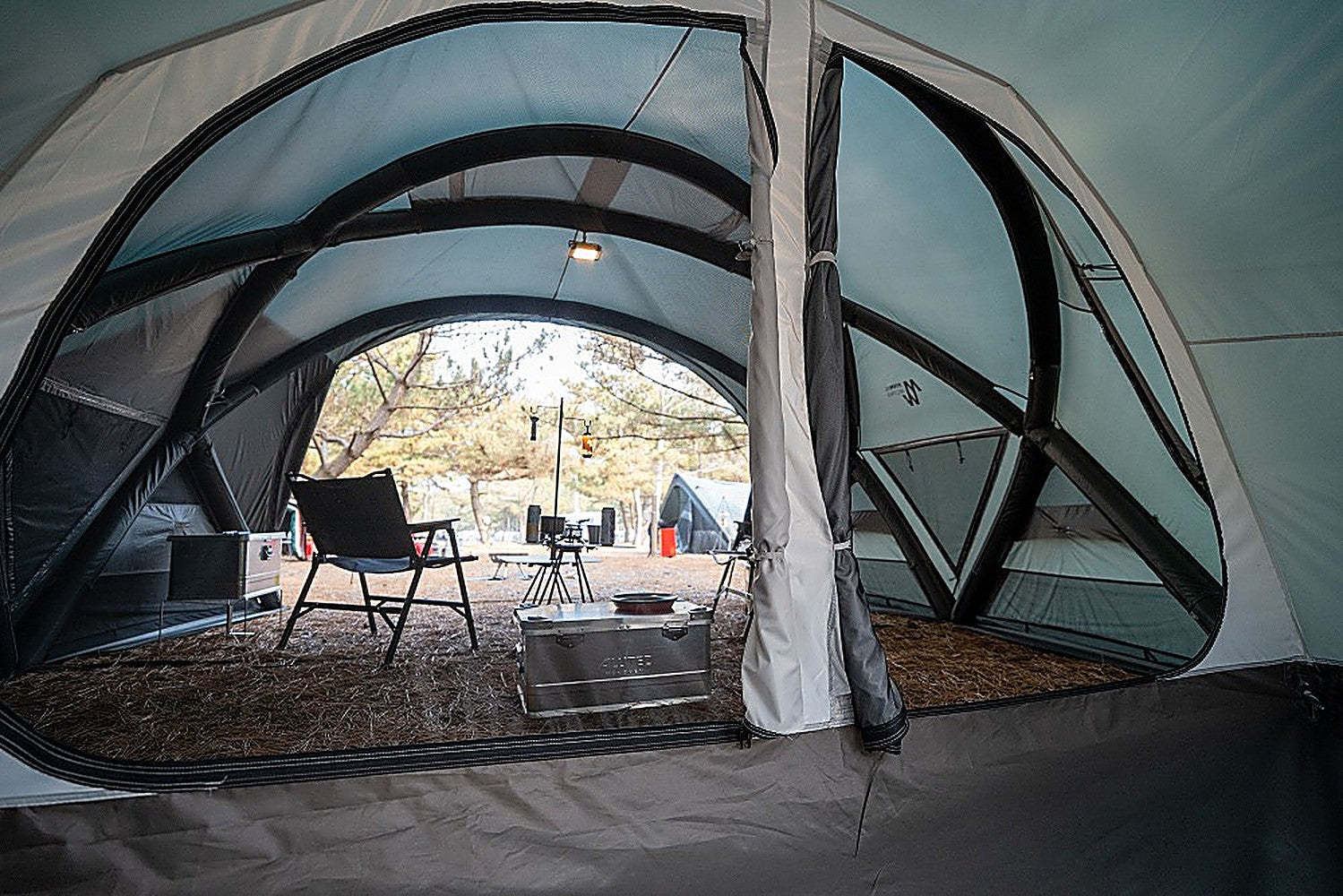 Vestibule Inner Tent zone inside Shelter GM with large mesh panels, folding chair and aluminum camp box
