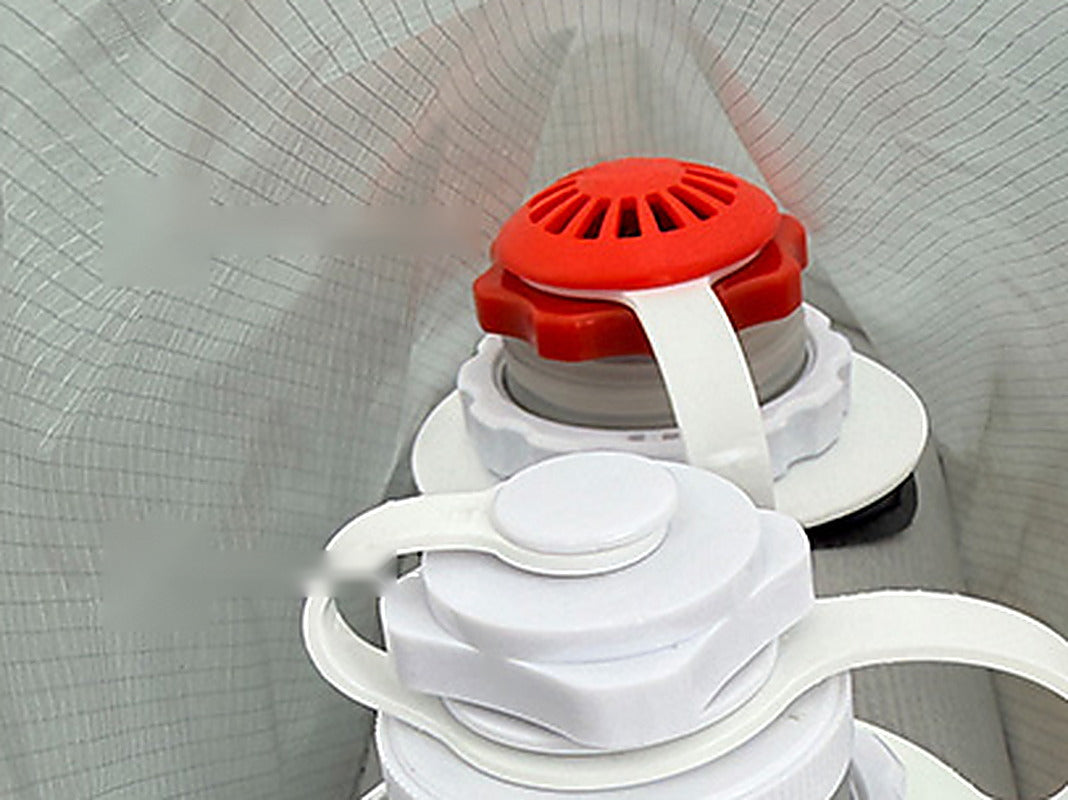 Close-up of the red pressure-relief valve cap and the white air valve on the tent beam.