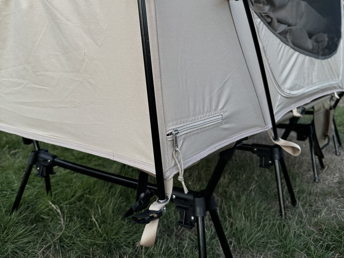 Neo Nest 80 floor corner strapped and buckled to the leg of a camp cot (cot sold separately).
