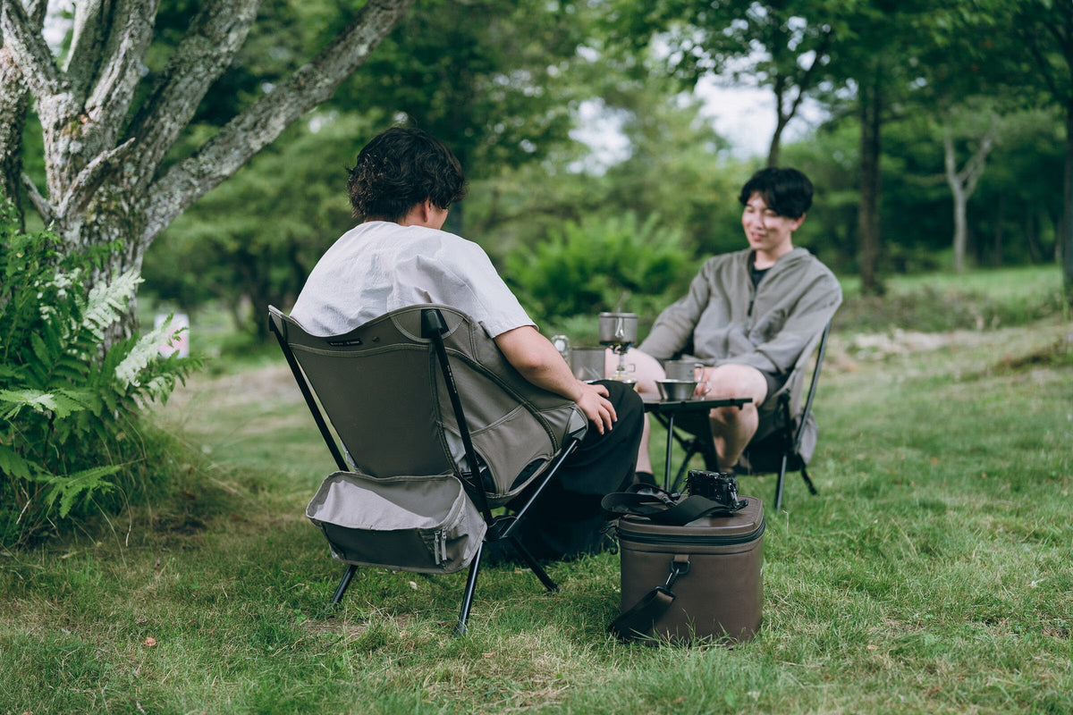 Noga Chair, Greige, two people seated and talking
