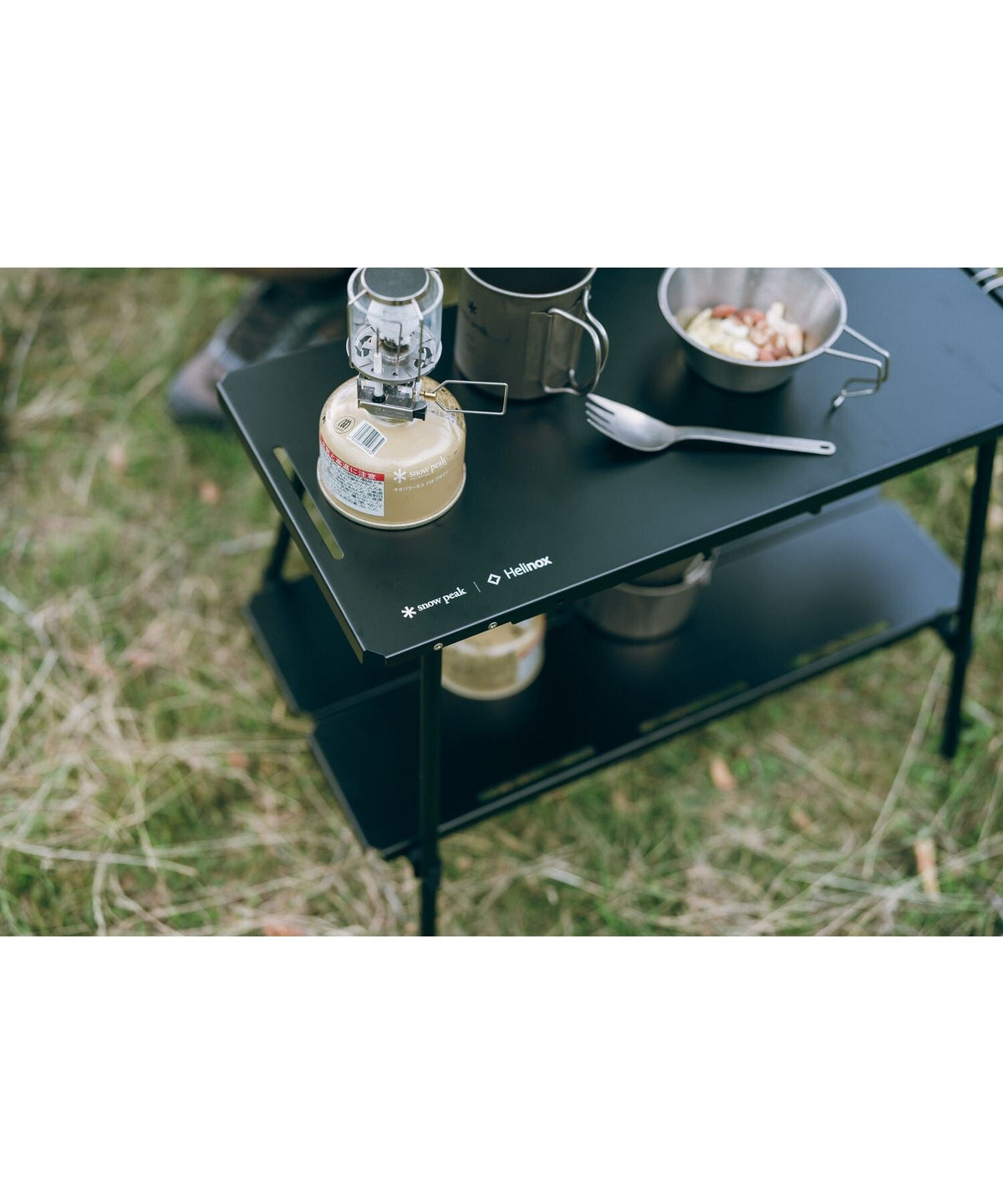 Noga Table, Black, close view of a lantern and bowl on the top