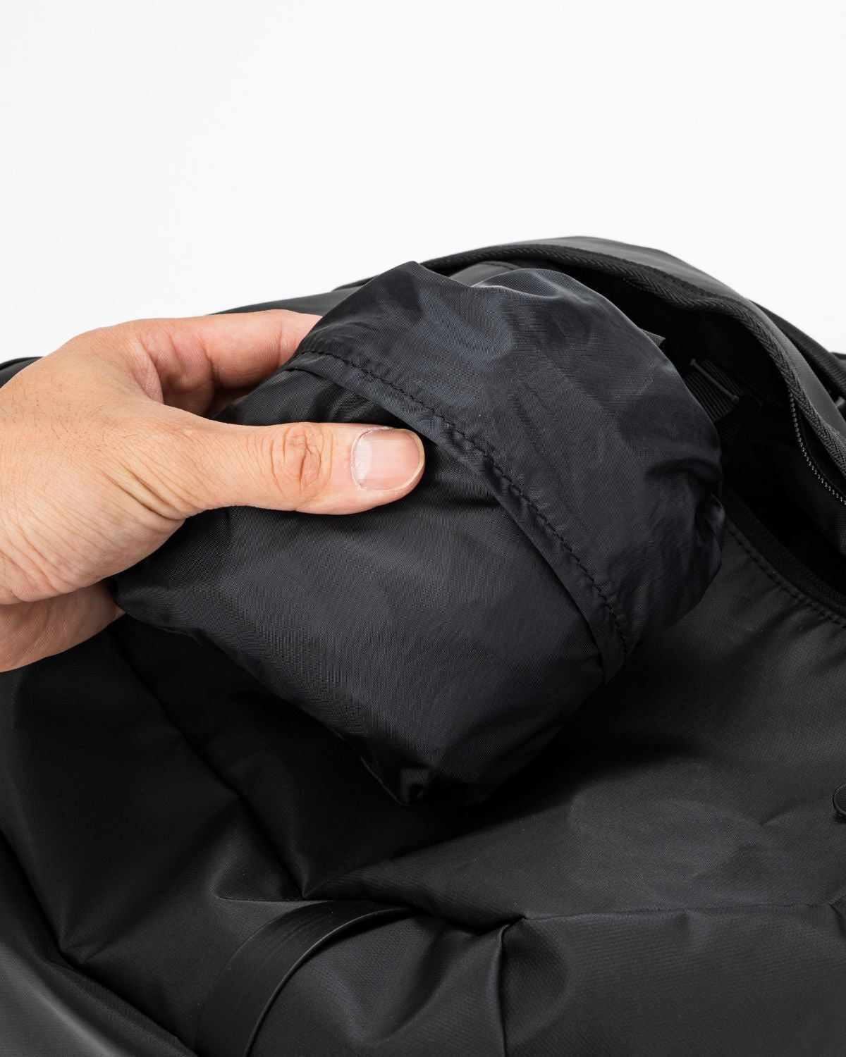 OT Duffel Bag, Black, backpack straps being stowed into their pocket