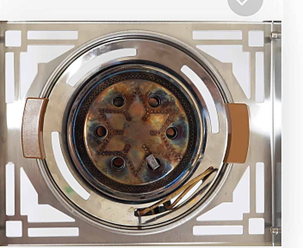 Uncoated burner head with heat discoloration and rust