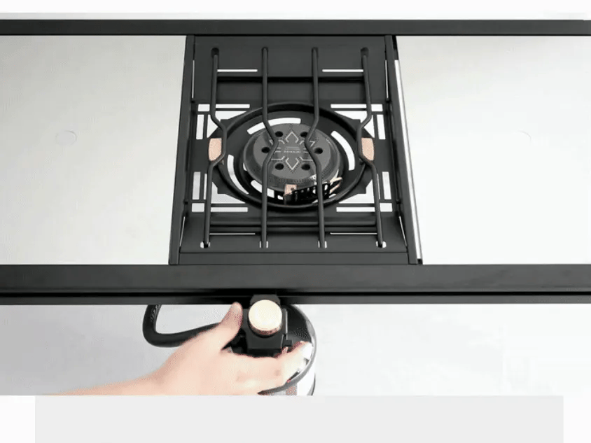 Hand adjusting the side regulator to fine-tune the Personal Flat Burner flame