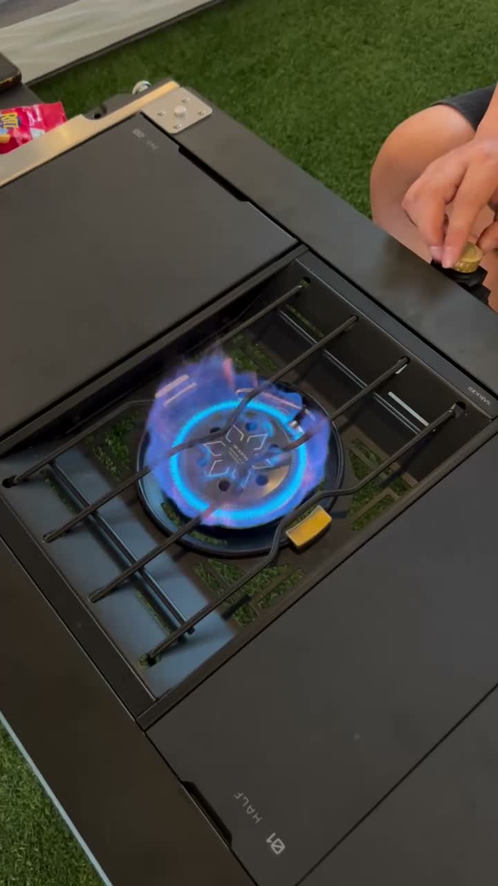 BigTent's Kevin lighting the Saikkiri Personal Flat Burner at a campsite, blue flame lit