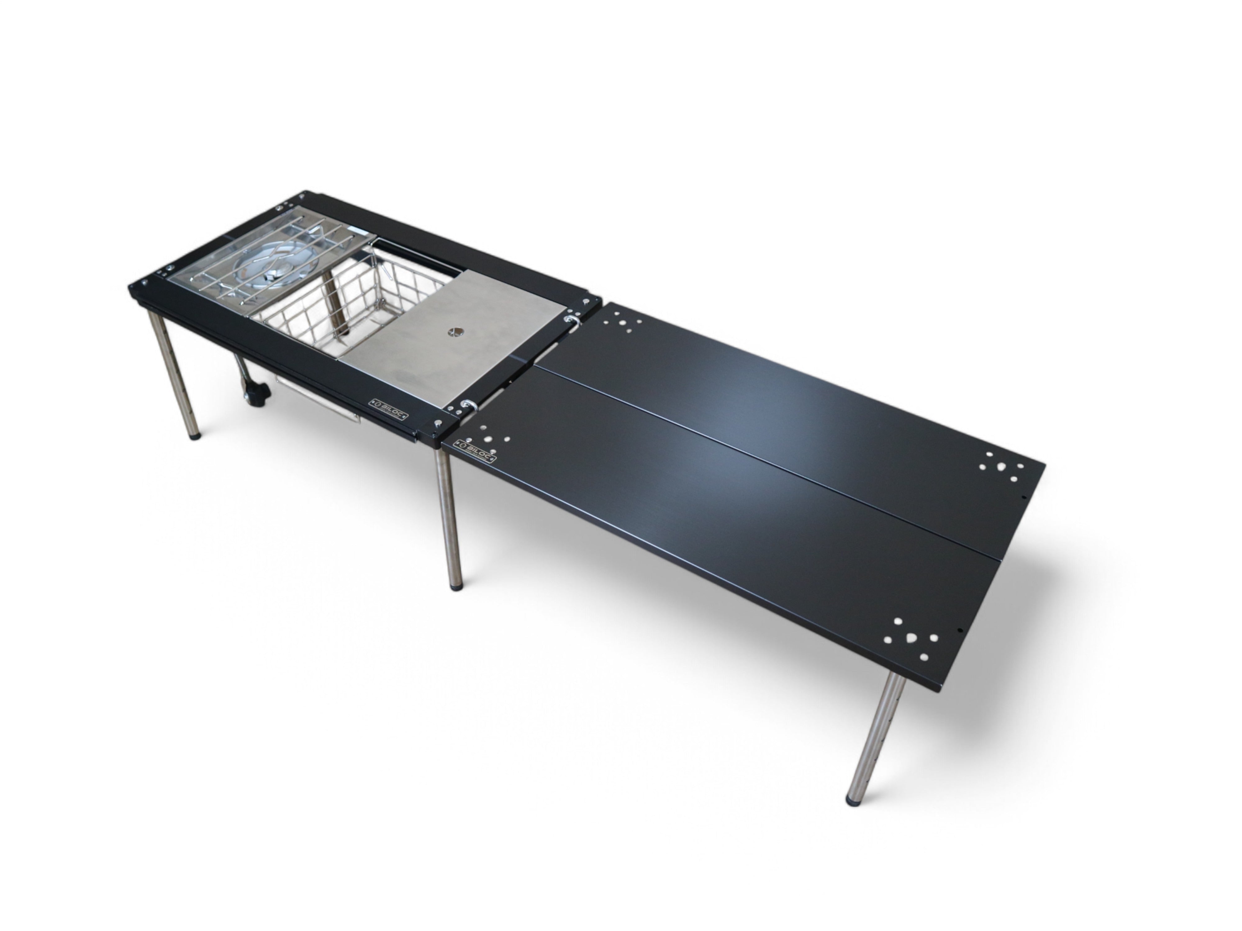 Black Ribera table bolted end-on to a Biloc IGT stove table, forming one long continuous run.
