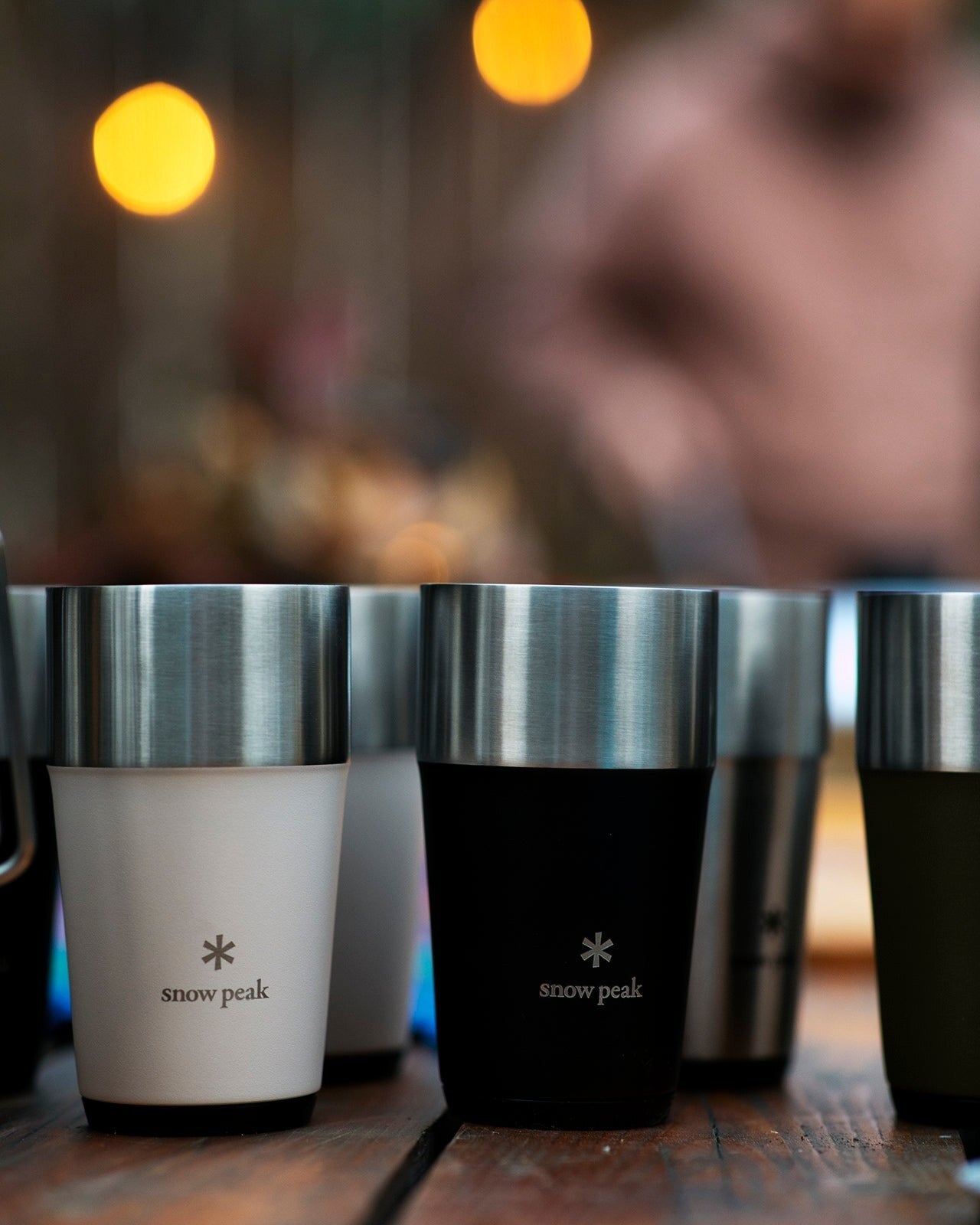 Shimo Tumbler, all four colors lined up on a wooden table at dusk