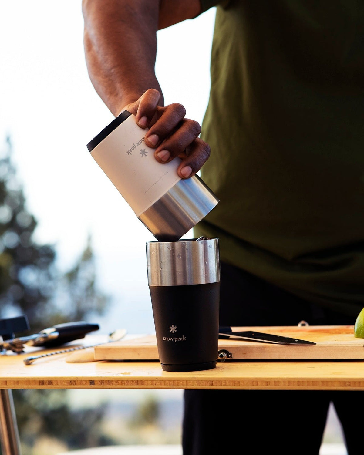 Shimo Tumbler, Sand and Black, stacking two tumblers on an outdoor prep table
