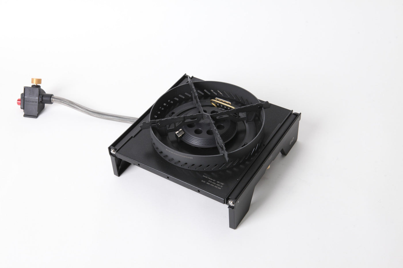 BUENOFE Stove Windscreen fitted to the BX-09 Table Burner laid flat in an IGT frame with the gas hose and regulator attached, shown in three-quarter view on a white background as a complete tabletop cooking setup.