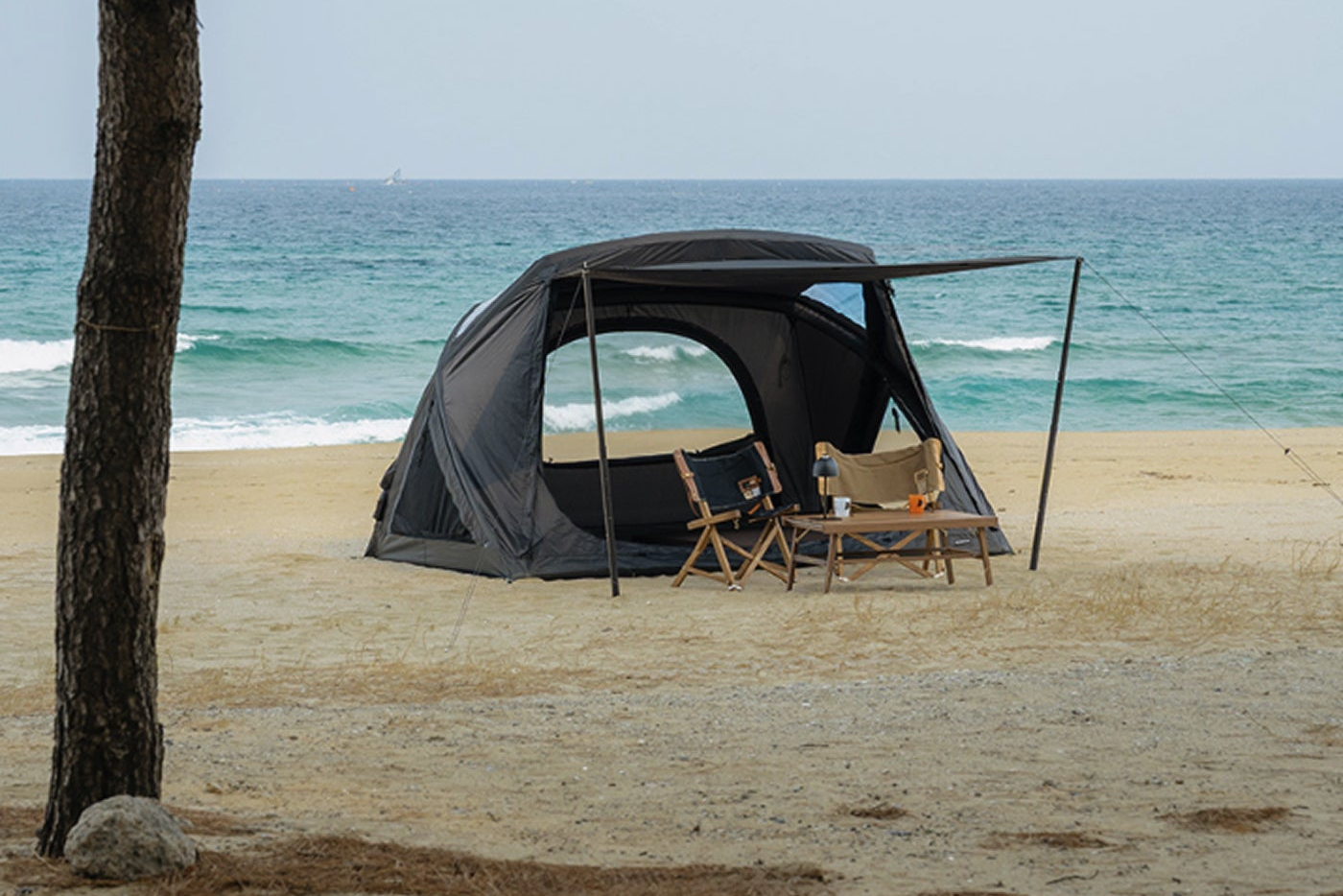 Geo-Air 4 tent set up on coastal sand, side profile showing peaked cabin silhouette and TPU skylight panel