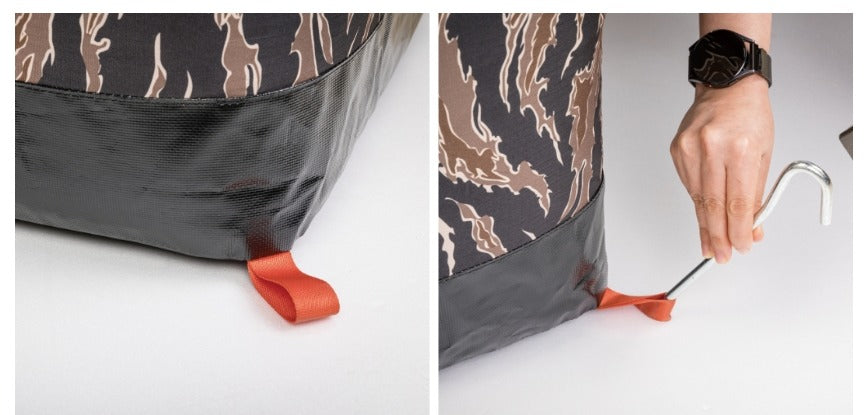 Orange peg loop at a base corner, staked into the ground